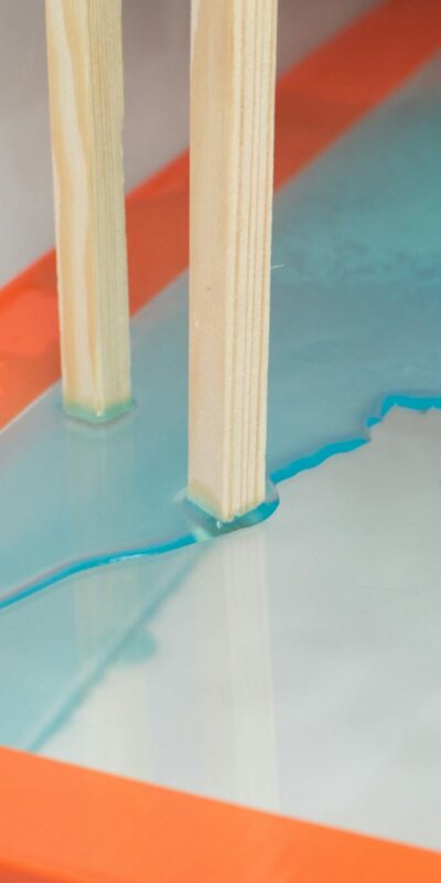 Wooden planks on glass table with spilled water