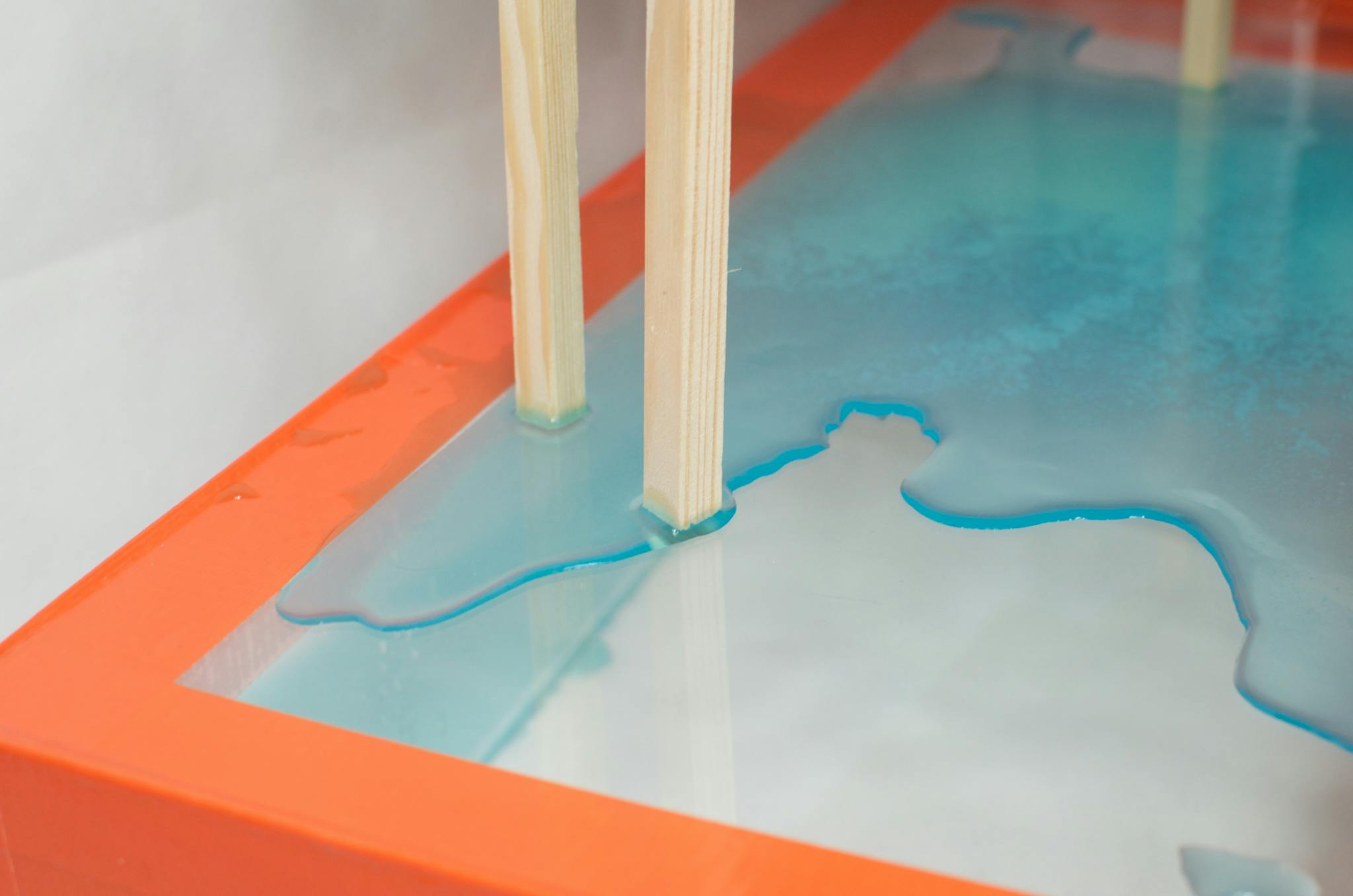 Wooden planks on glass table with spilled water